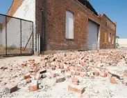  ?? Robyn Beck / AFP / Getty Images 2008 ?? Bricks that fell from a building during a 5.4-magnitude earthquake litter an alleyway in Pomona, on July 29, 2008.