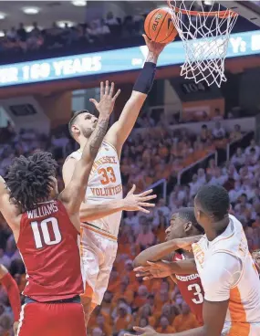  ?? RANDY SARTIN/USA TODAY SPORTS ?? Tennessee forward Uros Plavsic goes to the basket against Arkansas Razorbacks forward Jaylin Williams (10) on Saturday.