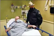  ??  ?? Kevin Kresen, 58, of Candor, N.Y., and New York State Police Sgt, Jason Cawley, in Lourdes Hospital, in Binghamton, N.Y.