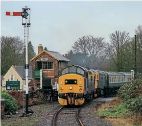  ?? Chris Gee ?? No. 37250 was in use on a passenger train for the first time since 2019 and on Christmas Eve 2021 partnered with 33035 and the recently restored rake of BR blue and grey Mk.2 coaches at the Wensleydal­e Railway. Here it arrives at Bedale on the 11.15 Constable Burton-Leeming Bar shuttle.