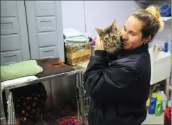  ?? Photo by Ernest A. Brown ?? Woonsocket Assistant Animal Control Officer Tiffany Coles spends time with “Angel,” a year-old cat, at the Woonsocket Animal Shelter Wednesday.
