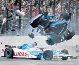  ?? Ron Graphman Associated Press ?? SCOTT DIXON’S car disintegra­tes over Jay Howard’s car coming out of Turn 1 at the Indianapol­is Motor Speedway. Dixon climbed out and was OK.