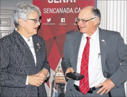  ?? JIM DAY/THE GUARDIAN ?? Daniel MacKinnon, owner/operator of Sandrae Farms in Brooklyn, P.E.I., chats with P.E.I. Lt.-Gov. Antoinette Perry after receiving the Senate Canada 150 medal Friday at Government House.