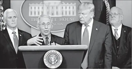  ?? CAROLYN KASTER/AP ?? Dr. Anthony Fauci, second from left, said in a 2015 interview that his Jesuit education had helped develop the “principles that I run my life by.”