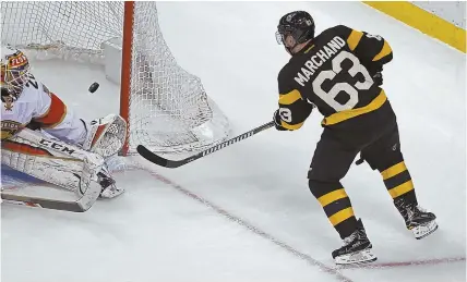  ?? STAFF PHOTOS BY JOHN WILCOX ?? TAMING THE CATS: Bruins winger Brad Marchand (above) beats goaltender Reto Berra for his 39th goal in the third period, and Patrice Bergeron (right) is congratula­ted on his emptynette­r in yesterday’s 5-2 rout of Florida at the Garden.