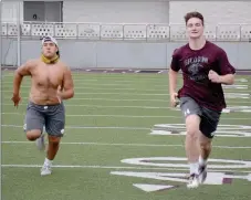  ?? Graham Thomas/Siloam Sunday ?? Siloam Springs football players J.P. Wills, left, and Hunter Talley run sprints during practice on Thursday at Panther Stadium. The Panthers wrapped up their first week of workouts since being allowed back after missing more than two months because of the covid-19 pandemic.