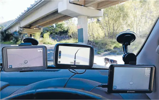  ??  ?? These are our three units posed for the purposes of this report. In the right-hand bottom corner is the Navman Mivue LM, mounted in exactly the right place so that you obscure the least of the screen and still allow the forward-facing camera to do its...