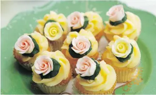  ??  ?? Miniature cupcakes topped with rose buds made by Jessica McGovern.