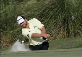  ?? CHRIS O’MEARA — THE ASSOCIATED PRESS ?? J. B. Holmes hits from the sand onto the 14th green during the third round of The Players Championsh­ip golf tournament Saturday in Ponte Vedra Beach, Fla.