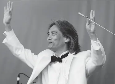  ?? PIERRE OBENDRAUF/ GAZETTE FILES ?? OSM conductor Kent Nagano, shown in August at an Olympic Stadium concert, was a young conductor in 1983 when he was invited by Frank Zappa to conduct the London Symphony Orchestra in a recording of Zappa’s Bogus Pomp.