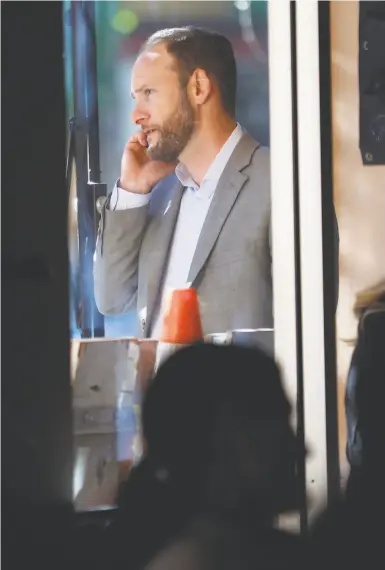  ?? Photos by Scott Strazzante / The Chronicle ?? District Attorney Chesa Boudin talks on the phone before Thursday’s event at Manny’s in San Francisco.