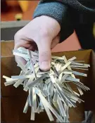  ?? DANAJENSEN THE DAY ?? Volunteer Jacob Valdez of Groton takes a handful of metal nose strips to place on a scale to weigh to make sure the correct number is used to fill an order Friday at Hillery Company in Groton.