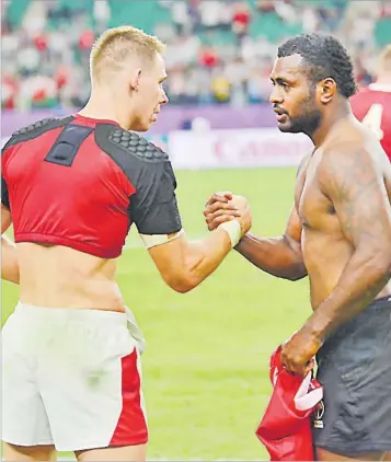  ?? Picture: JOVESA NAISUA Picture: JOVESA NAISUA ?? Flying Fijians fullback Kini Murimuriva­lu with Wales fullback Liam Williams exchange jerseys after their pool match at the Oita Stadium in Oita, Japan last week.