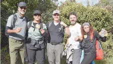  ?? ?? A group celebrates completing the Boundary Walk.