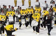  ??  ?? Tiger time: Royal Malaysian Armed Forces band members dressed as ‘Rimau’ – the SEA Games mascot – preparing to do their part.