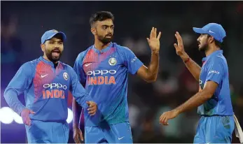  ?? — AP ?? Jaydev Unadkat ( centre) celebrates the dismissal of Bangladesh’s Mehidy Hasan with team mates in a tri- series T20 match in Colombo on Thursday. Indian won by six wickets.