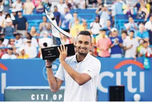  ?? PATRICK SEMANSKY/ASSOCIATED PRESS ?? Nick Kyrgios, of Australia, poses for photos with his trophy after defeating Daniil Medvedev in the men’s final of the Citi Open.