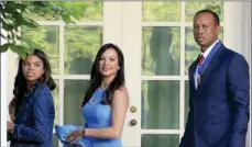  ?? The Associated Press ?? Tiger Woods (right) with his daughter Sam Alexis Woods (left) and his ex-girlfriend Erica Herman walk along the Colonnade at the White House following a ceremony when the Presidenti­al Medal of Freedom was awarded to him in 2019.