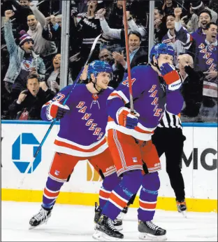  ?? Jessie Alcheh The Associated Press ?? New York Rangers’ Kaapo Kakko (24) and Adam Fox (23) celebrate after Kakko’s goal against the Montreal Canadiens at Madison Square Garden. The Rangers won 3-2.