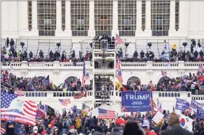  ?? John Minchillo / Associated Press file photo ?? In this Jan. 6, 2021, file photo insurrecti­onists loyal to President Donald Trump breach the Capitol in Washington.