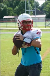  ??  ?? Atkins junior Zach Berkemeyer prepares to throw a pass at practice Aug. 13. First-year head coach Matt Porter said Berkemeyer has a good arm and manages the game well.