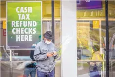  ?? BEBETO MATTHEWS/ ASSOCIATED PRESS ?? Millions have received stimulus payments through direct deposit, but those without bank accounts must wait for paper checks, which many will cash at check cashing stores such as this one in Brooklyn, New York.