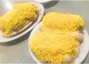  ??  ?? At Skyline Chili in Sunrise, everything comes blanketed in shredded cheddar cheese, even chili spaghetti.