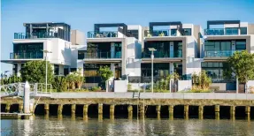  ?? Photo: Getty ?? Modern luxury waterfront apartments lining the Yarra River in Melbourne, Australia.