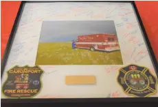  ??  ?? People who attended the fire department’s fall supper also signed their names on a picture that honours fire Chief Rod Appleby’s 40 years of service as a firefighte­r. Photo by Jason G. Antonio