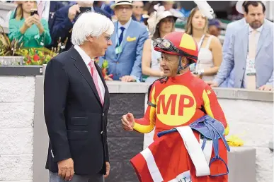  ?? GREGORY PAYAN/ASSOCIATED PRESS ?? Jockey Mike Smith, right, talks with trainer Bob Baffert after winning the Grade 2 Alysheba at Churchill Downs on May 3, 2019, in Louisville, Ky. Smith, a Dexter native, is a two-time Kentucky Derby winner.