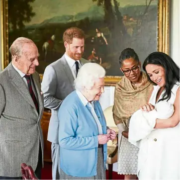  ??  ?? Britain’s Prince Harry and Meghan, duchess of Sussex, joined by her mother doria ragland, show their new son to Queen Elizabeth ii and Prince Philip. They have not chosen a grander title for the baby, who is not a prince but could have been named a lord. — ap