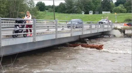  ?? DON PLANT/Special to The Daily Courier ?? The flow in Mission Creek nearly quadrupled overnight Monday, triggering some localized flooding and causing the temporary closure of the KLO Road bridge as crews worked to clear debris underneath the span.