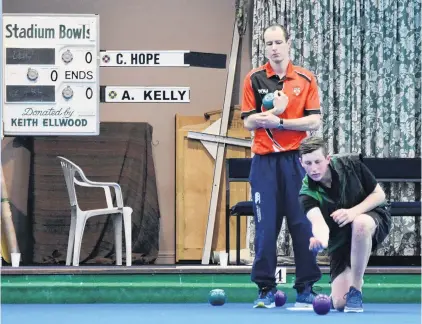  ?? PHOTO: WAYNE PARSONS ?? Stand and deliver . . . Caleb Hope (Gore) gets the second set under way while his opponent, Andrew Kelly (Canterbury), waits behind deep in thought during the Dunedin regional qualifying round of the Internatio­nal Singles at the Dunedin Bowls Stadium on Saturday.