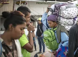  ?? AFP/Getty Images ?? Central American migrants traveling in a caravan to the United States, look for spaces Nov. 30 after being relocated at a new temporary shelter in east Tijuana, Baja California State, Mexico.