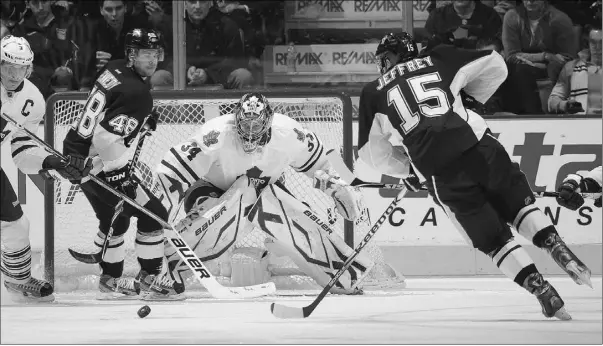  ?? Claus Andersen, Gety Image
s ?? Pittsburgh Penguins’ Dustin Jeffrey looks to get a shot away on Maple Leafs goalie James Reimer in Toronto on Wednesday.