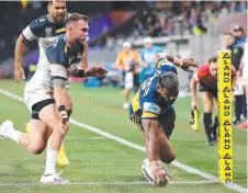  ??  ?? Maika Sivo scoring one of his four tries for the Eels last night.