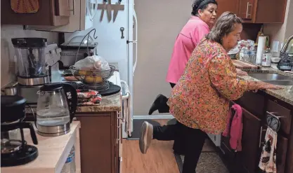  ?? MARK HENLE/ARIZONA REPUBLIC ?? Marlene Carrasco, left, and Carmen Garcia exercise in Garcia’s Arizona apartment. Caregivers are needed more than ever as the U.S. population ages. Arizona is especially in need.