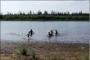  ?? OLGA BURTSEVA VIA AP ?? In this handout photo provided by Olga Burtseva, children play June 21 in the Krugloe lake outside Verkhoyans­k, the Sakha Republic, which logged a temperatur­e of 100.4 F in Siberia about 2900miles northeast of Moscow, Russia.