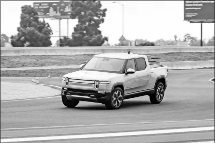  ?? COURTESY OF EDMUNDS VIA AP ?? The 2022 Rivian R1T is the Edmunds Editor’s Choice pick. The first all-electric pickup, the R1T impressed editors at Edmonds with its practical utility features, formidable performanc­e and a high-tech interior.