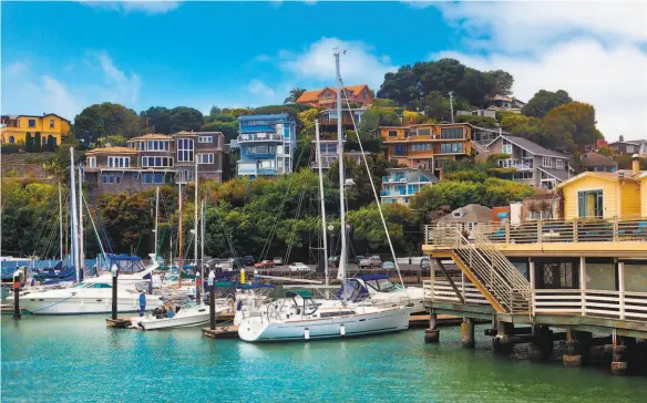  ?? Shuttersto­ck ?? Above: Upscale homes in Tiburon can include docks and decks overlookin­g the water. Below left: Hillside homes overlookin­g the water in Tiburon are highly coveted. Below right: Sailing in Richardson Bay is a hobby among some of Tiburon’s residents.