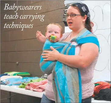  ?? STAFF PHOTO BY ANDREW RICHARDSON ?? Volunteer baby wearing educator Jessica Grimm teaches mothers how to properly secure their child with a woven wrap at a free-to-attend meeting hosted by the Southern Maryland chapter of Babywearin­g Internatio­nal, held at Grace Lutheran Church in La...