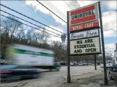  ?? Steph Chambers/Post-Gazette ?? A sign declaring “We are essential and open” is posted Wednesday outside Ronnie’s Tire Service in Carrick.