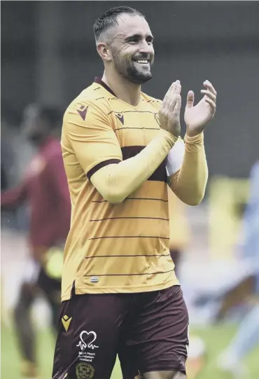  ??  ?? 0 Peter Hartley applauds the Motherwell fans after their 4-0 Betfred Cup win over Annan Athletic.