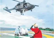  ?? ?? Indian Coast Guard and Indian Navy personnel during medical evacuation of a Filipino crew member from MV Lyric Poet. The crew member's health deteriorat­ed due to suspected Covid and has been shifted to INHS Sanjivni hospital.