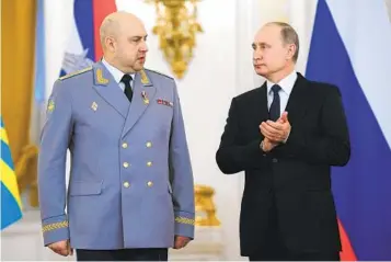  ?? ALEXEI DRUZHININ SPUTNIK, KREMLIN POOL VIA AP ?? Russian President Vladimir Putin applauds Gen. Sergei Surovikin during a 2017 awards ceremony.