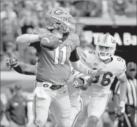  ?? Mike Ehrmann Getty Images ?? JAKE FROMM completed 17 of 24 passes for 240 yards and three touchdowns in Georgia’s victory. Two of the touchdown throws went to Jermaine Holloman.