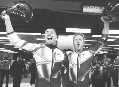  ?? JEAN LEVAC ?? London, Ont.’s Alex Kopacz, left, and Summerland, B.C.’s Justin Kripps cheer their gold-medal run in two-man bobsled on Monday.