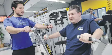  ?? PHOTOS: DAN JANISSE ?? Joe Najem, left, a University of Windsor kinesiolog­y student, works with Kevin Spratt at the St. Denis Centre as part of the Fit Together program, which provides fitness instructio­n to individual­s with autism spectrum disorder and intellectu­al...