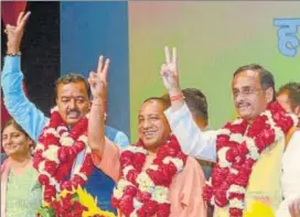  ?? ASHOK DUTTA /HT PHOTO ?? Yogi Adityanath with deputy CM picks Keshav Prasad Maurya (left) and Dinesh Sharma, after being named the next chief minister of UP in Lucknow on Saturday.