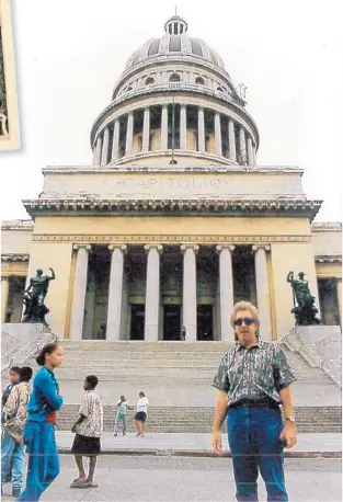  ?? COURTESY OF MARK SLIMP ?? Mark Slimp stands in front of El Capitolio, the National Capitol Building in Havana, Cuba. As senior field producer for ABC Network News from 1994 to 1997, Slimp made many trips to Cuba.